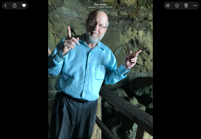 Naftali Schwartz at La Jolla Cove in San Diego, smiling in a blue shirt