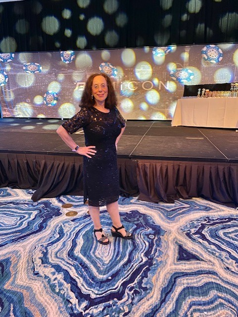 Linda Schwartz in an elegant black lace dress at an EntreCon event
