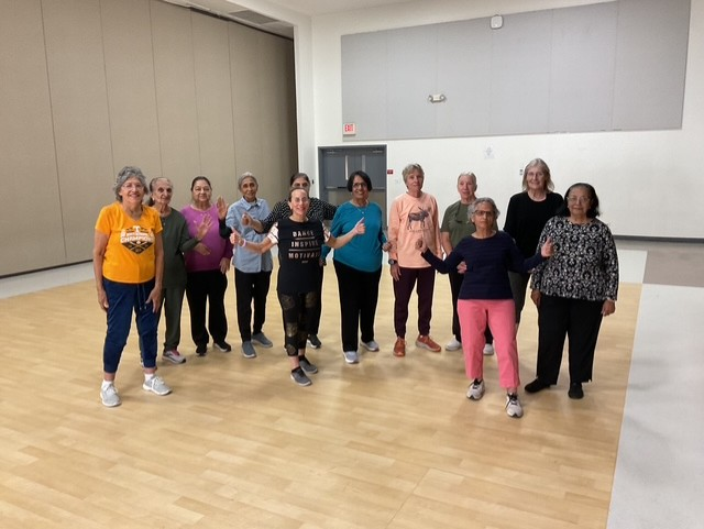 Mixed Zumba Gold class smiling together after a session